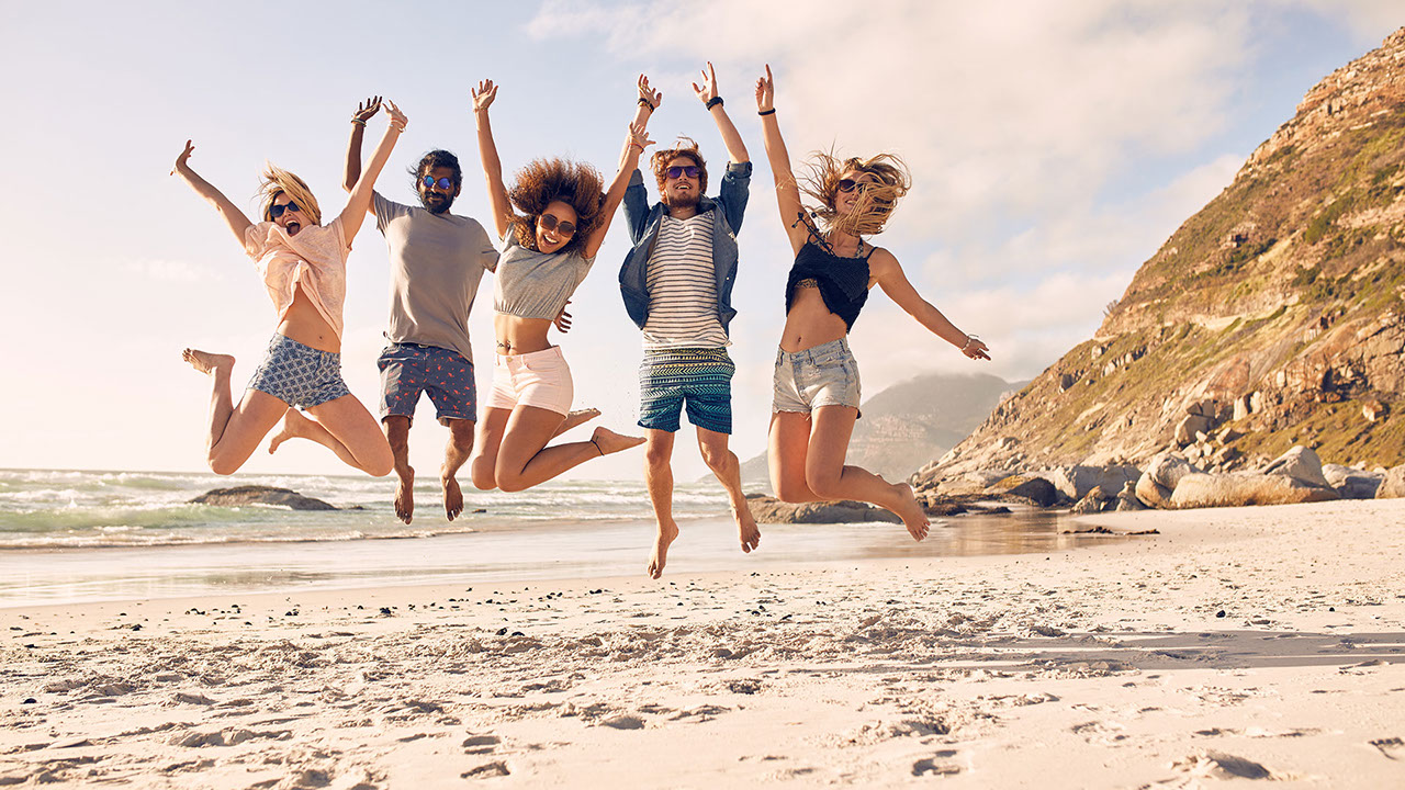 Group of friends on the beach having fun