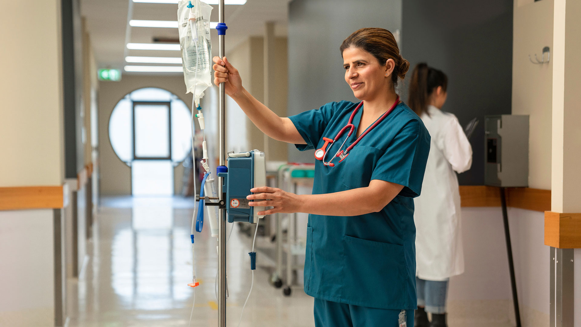 nursing student standing in front of machine