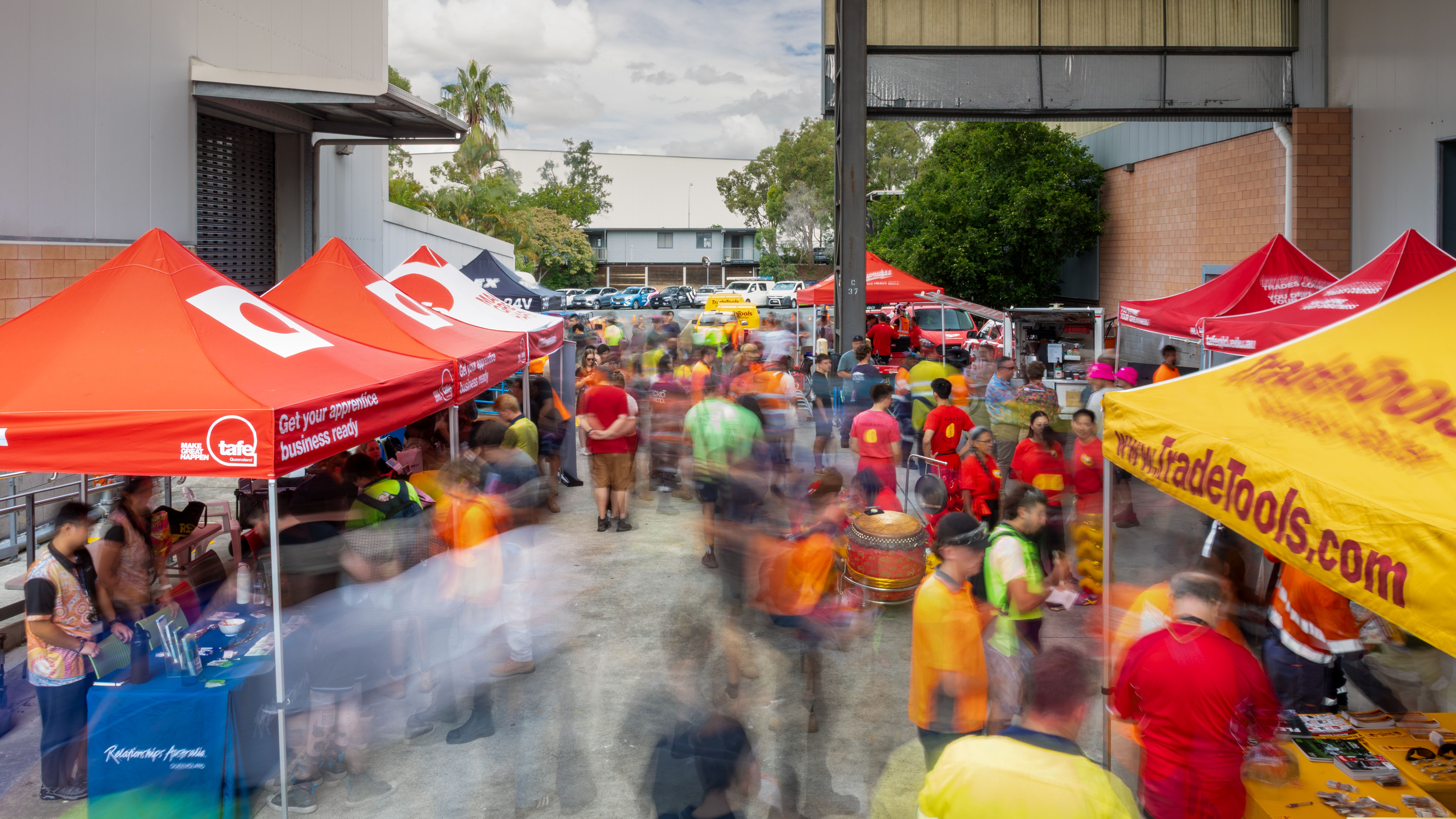 Industry event at campus for students, with marquee tents set up with a hyperlapse effect to create movement