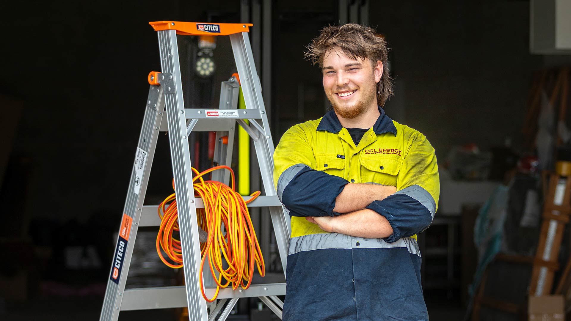 Caleb looking at the camera with ladder in the background