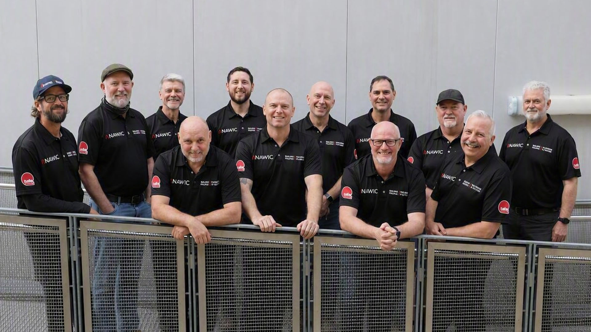 Image of a group of male TAFE Queensland staff who are wearning male allies branded shirts