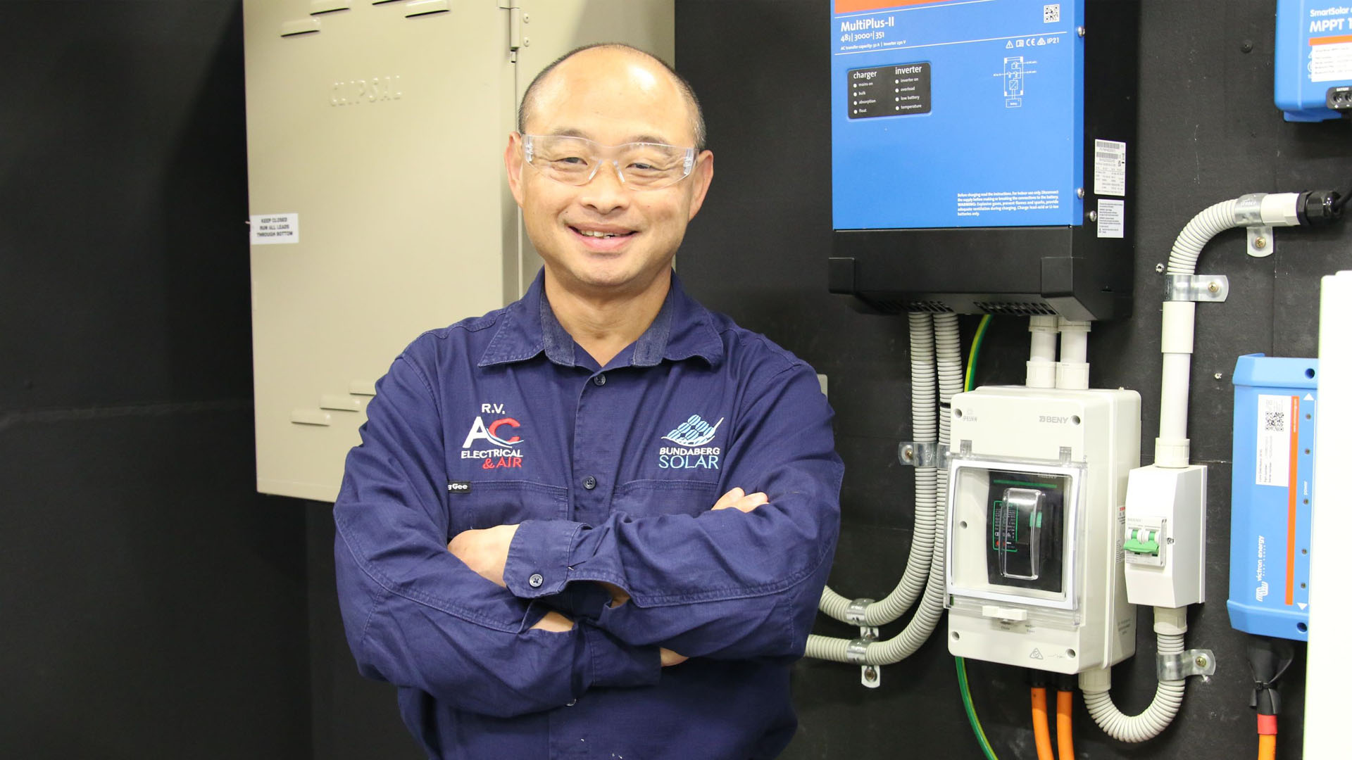 Image of electrician Arvin in front of batteries