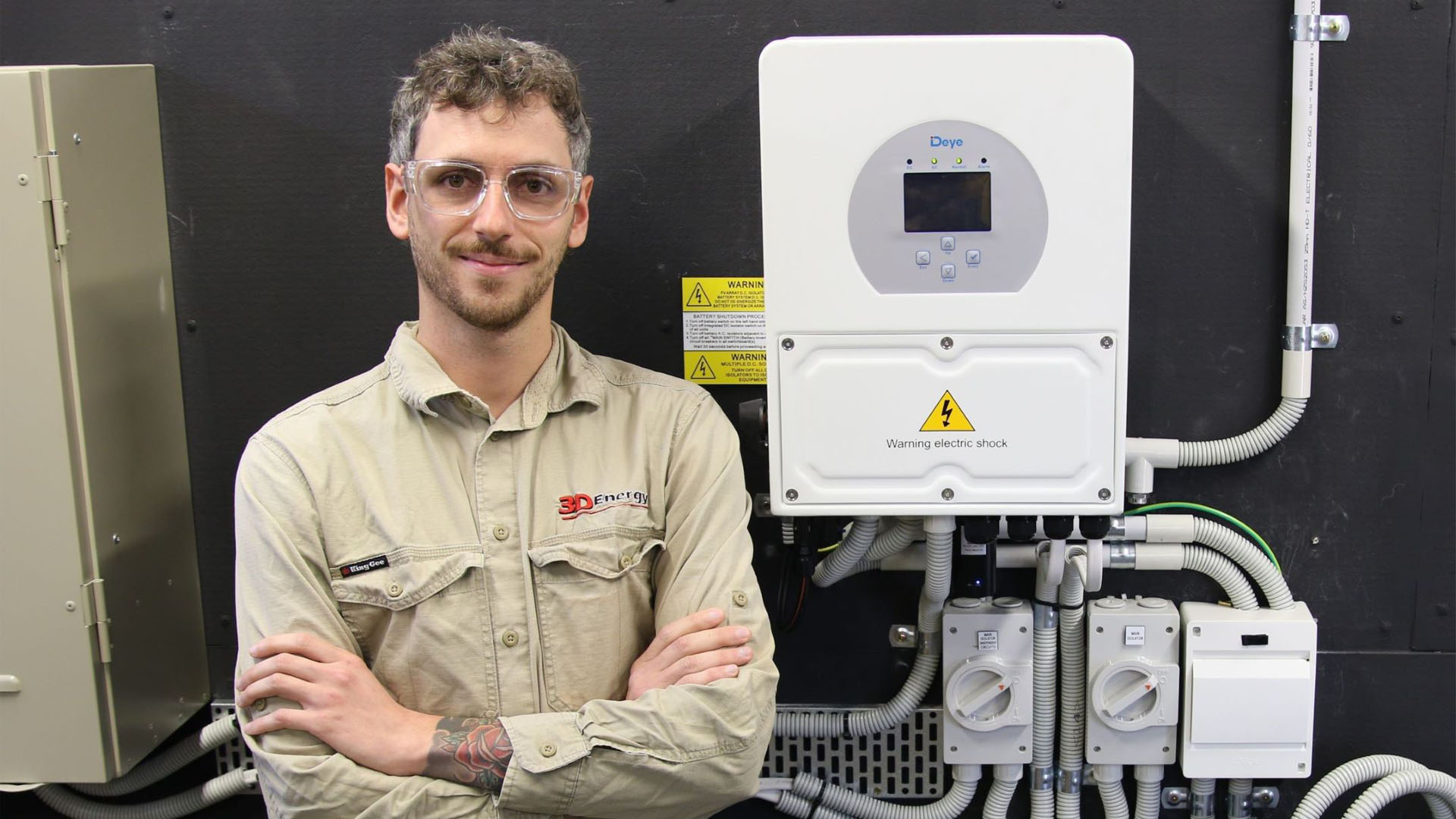 Image of electrician Harry in front of batteries