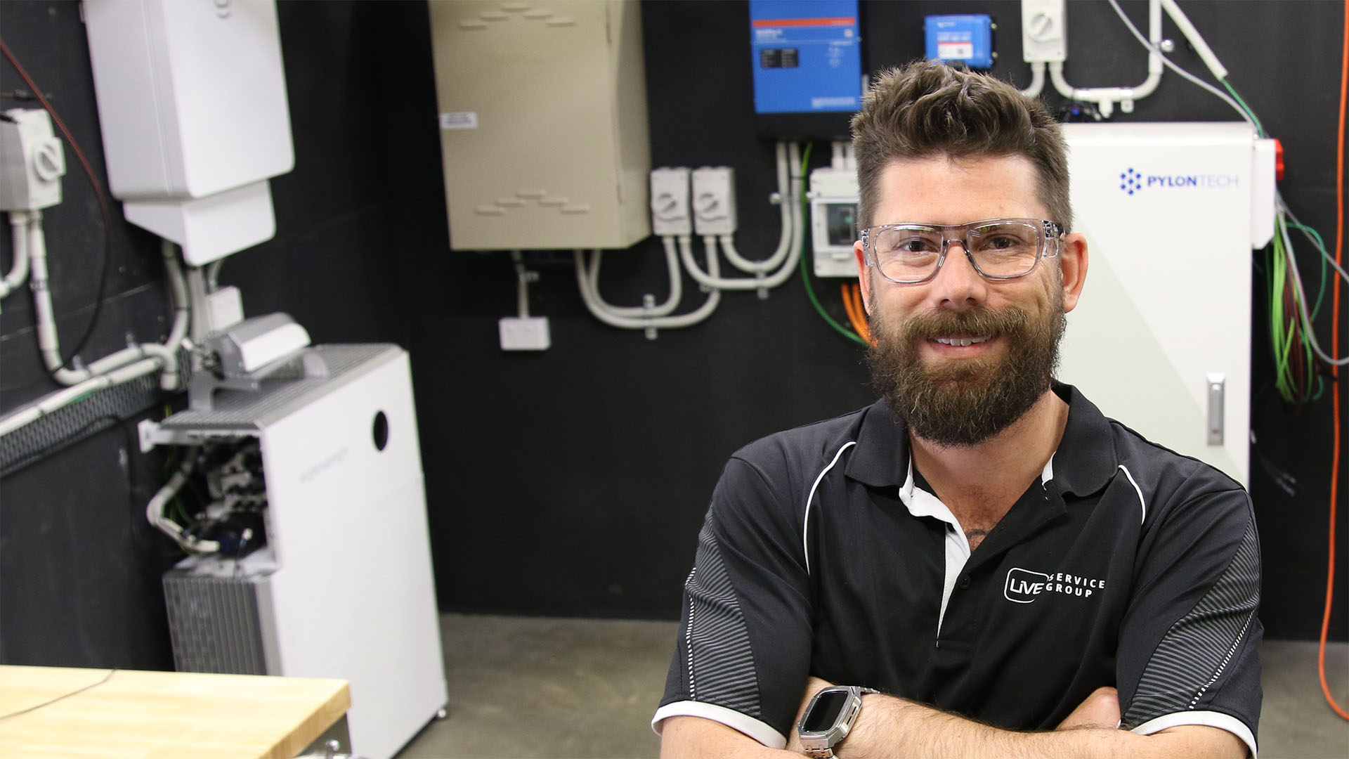 Image of electrician Nick in front of batteries