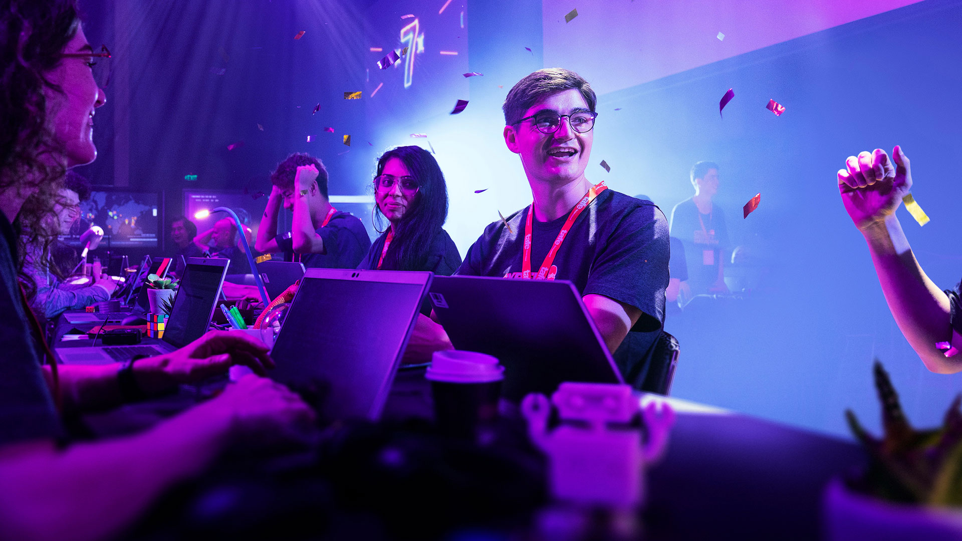 Students complete a hackathon with confetti falling from ceiling