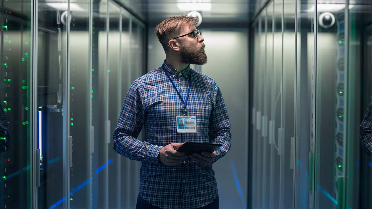 Photograph of a person in a computer server room